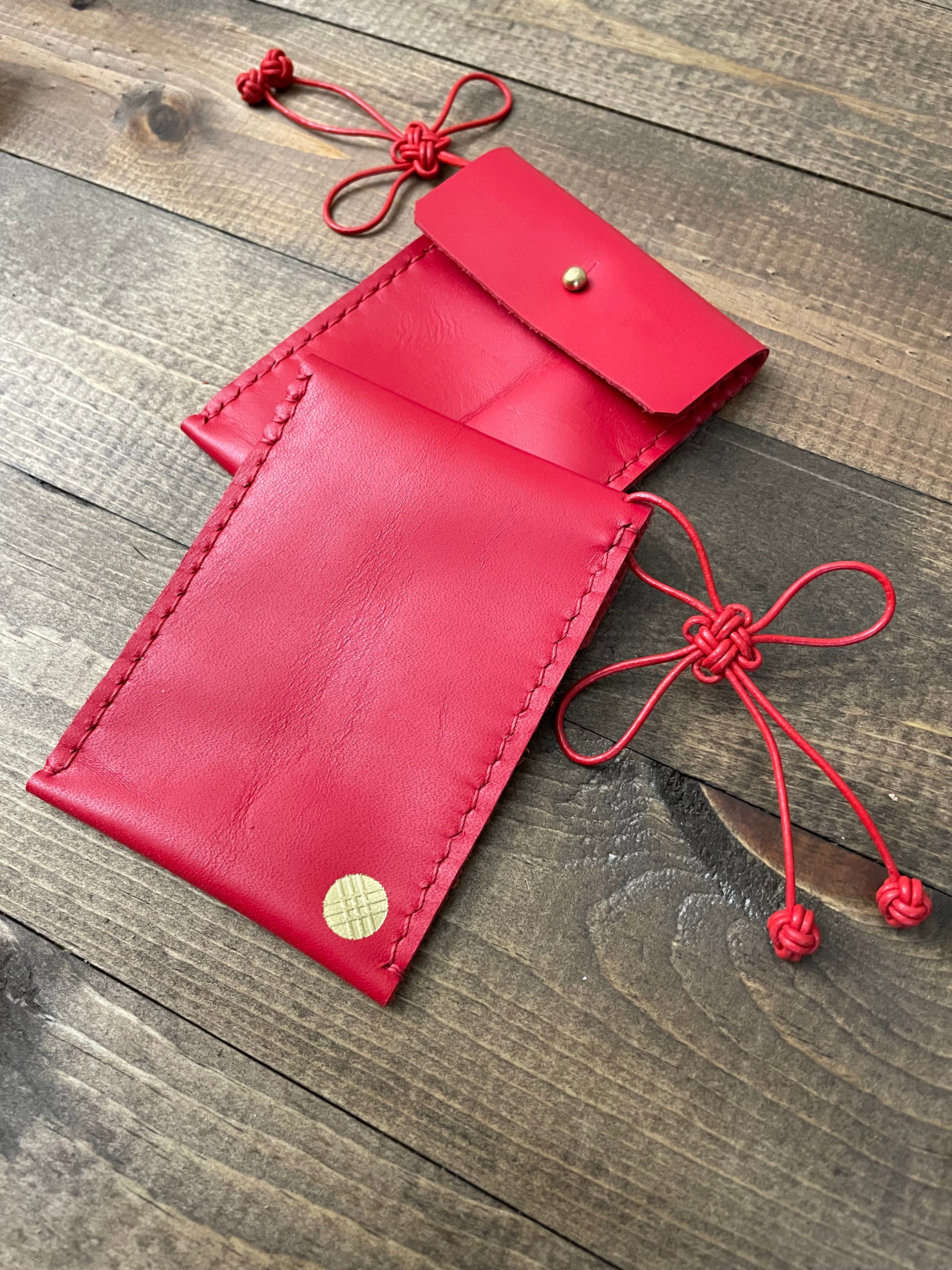 k(not) hong bao with lucky knot and clau knots and gold foil embossed logo